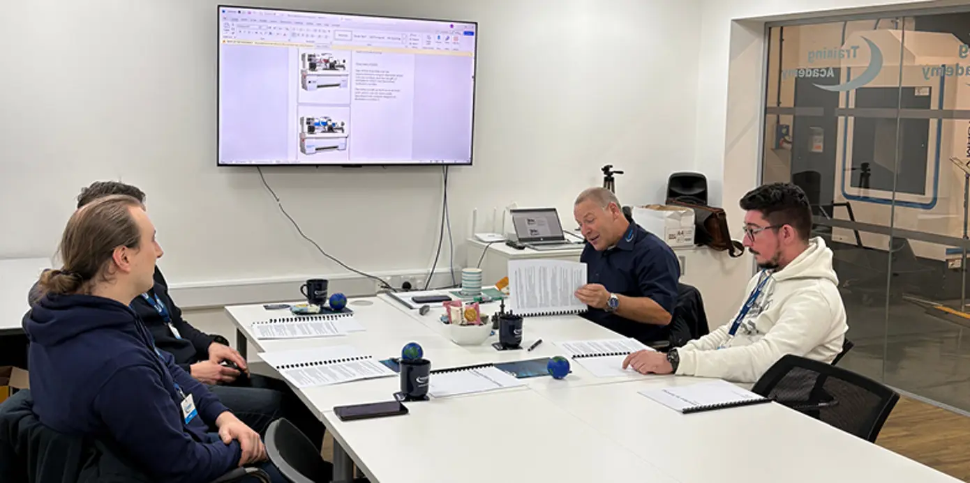 Colchester Training Academy teacher sat at a meeting table with 3 Fibrelite employees.