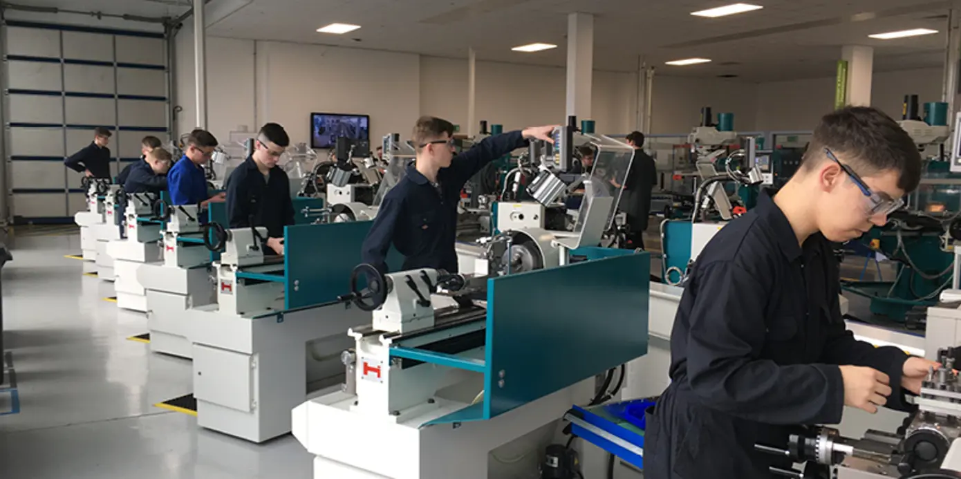 Seven students working on Colchester Student lathes